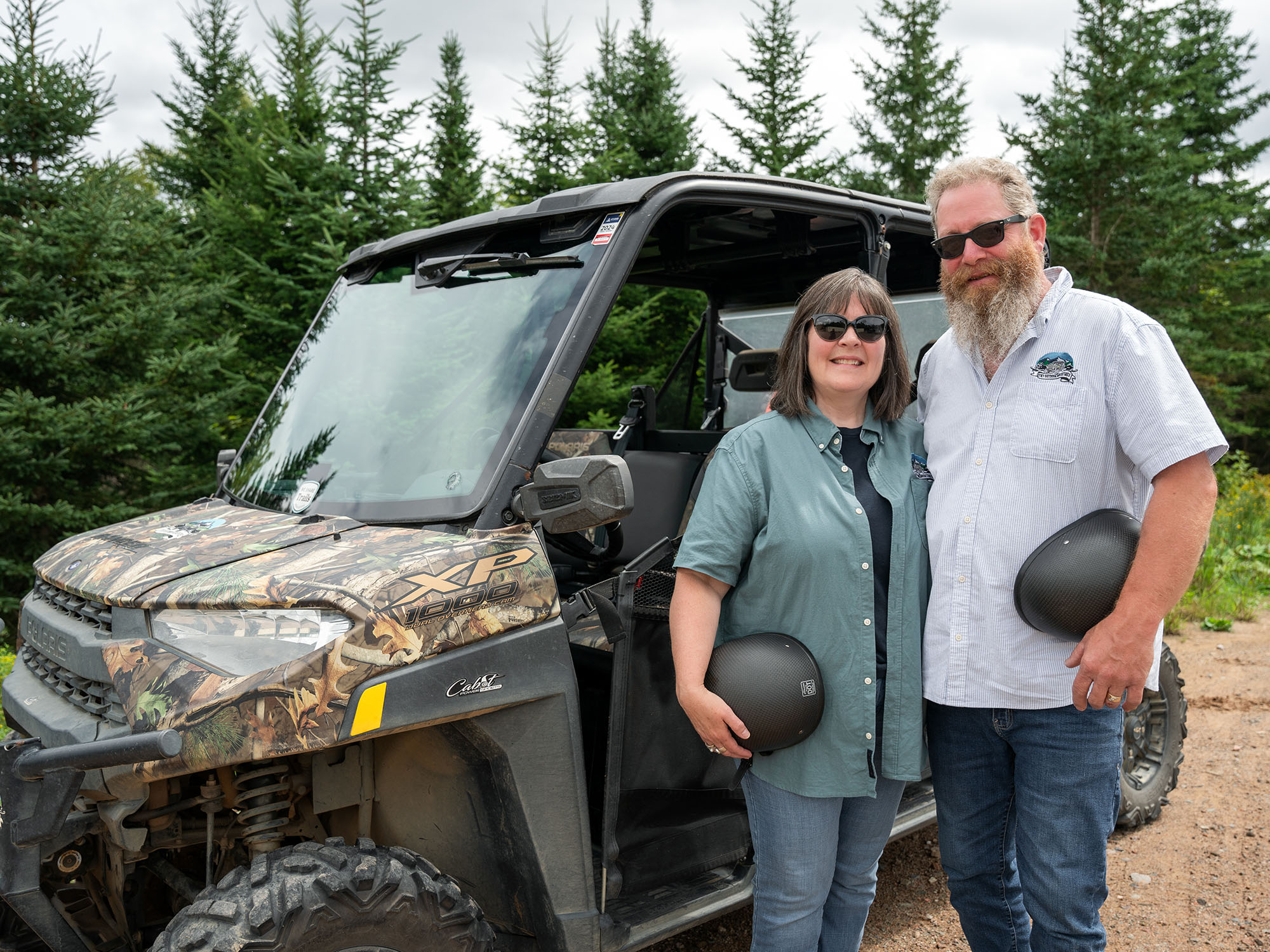 The owners and operators of TNT Adventures standing beside an ATV.